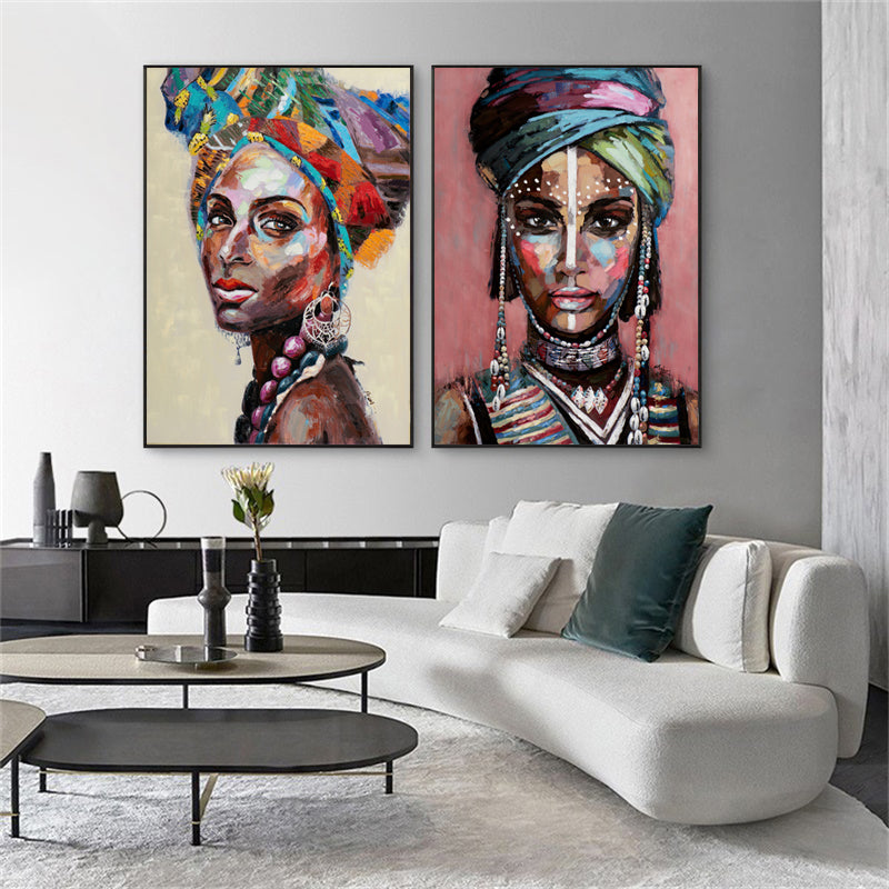 A beautifully framed 50cmx70cm canvas wall art depicting African women, showcasing vibrant colors and a modern black frame.