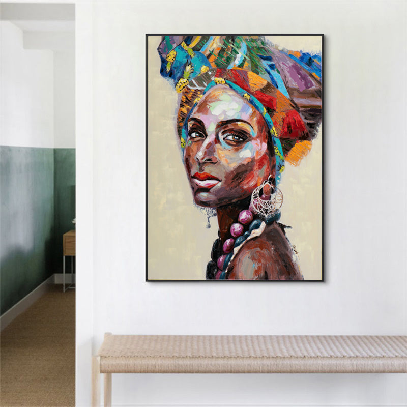 A beautifully framed 50cmx70cm canvas wall art depicting African women, showcasing vibrant colors and a modern black frame.