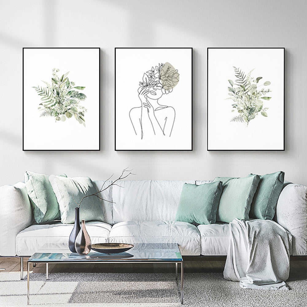 Three sets of Botanical Line Girl canvas wall art in black frames, showcasing elegant botanical designs.