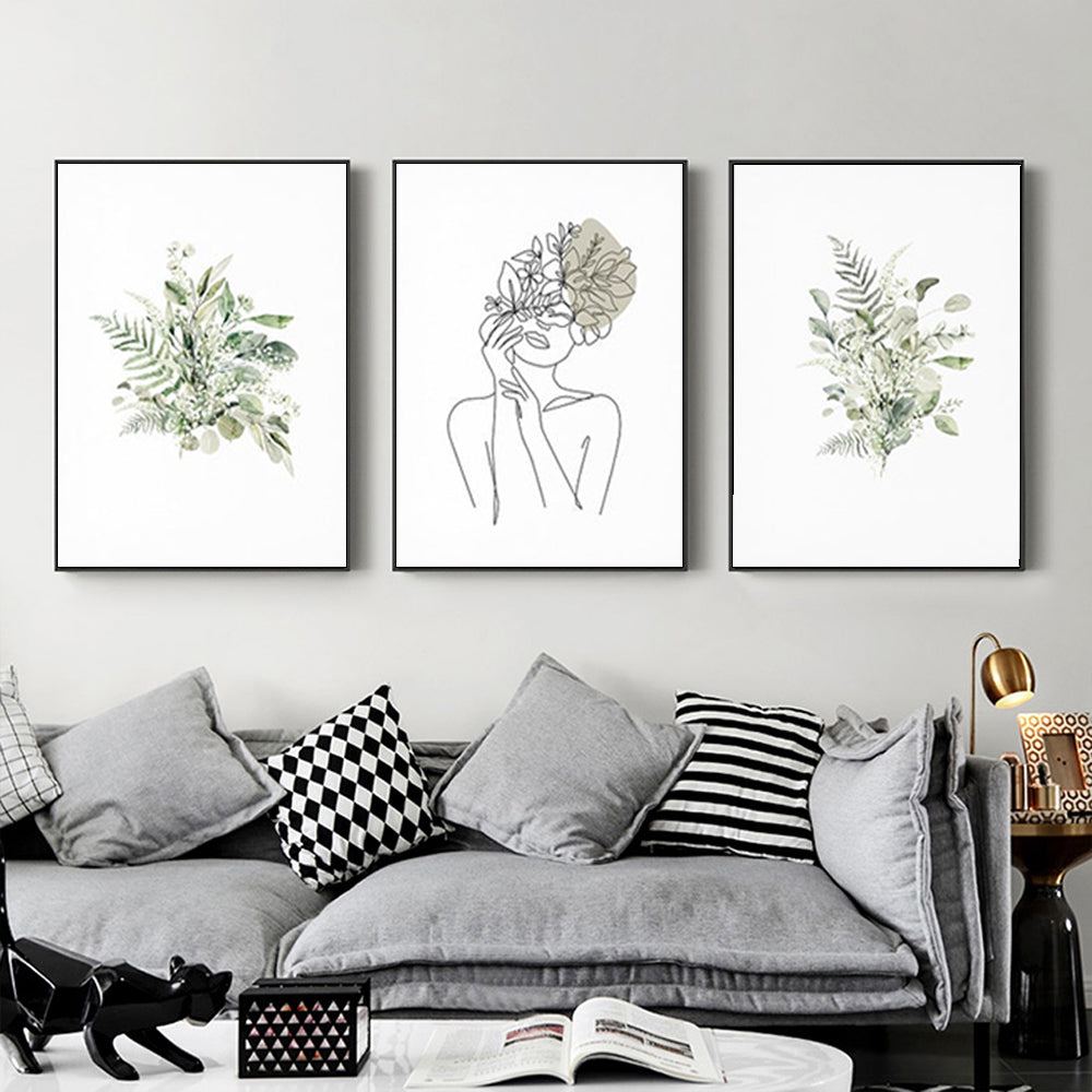 Three sets of Botanical Line Girl canvas wall art in black frames, showcasing elegant botanical designs.