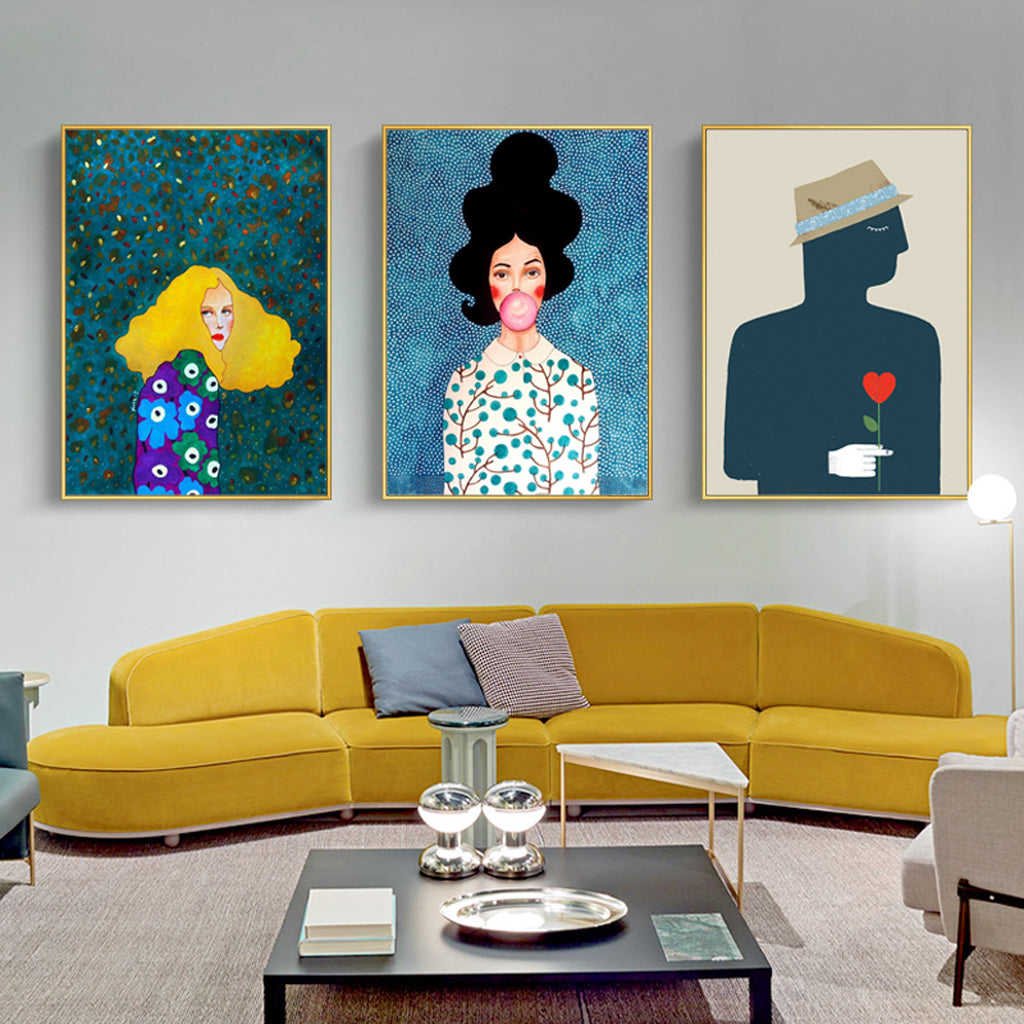 Three modern figure canvas wall art pieces in gold frames, showcasing vibrant colors and a floating effect, perfect for home decor.