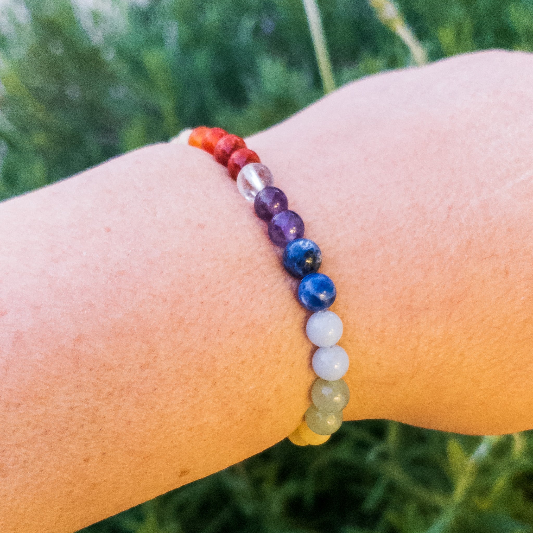 A beautifully crafted 7 Chakras Stone Beads Bracelet featuring semi-precious stones like Clear Quartz, Amethyst, and Red Jasper, symbolizing chakra alignment.