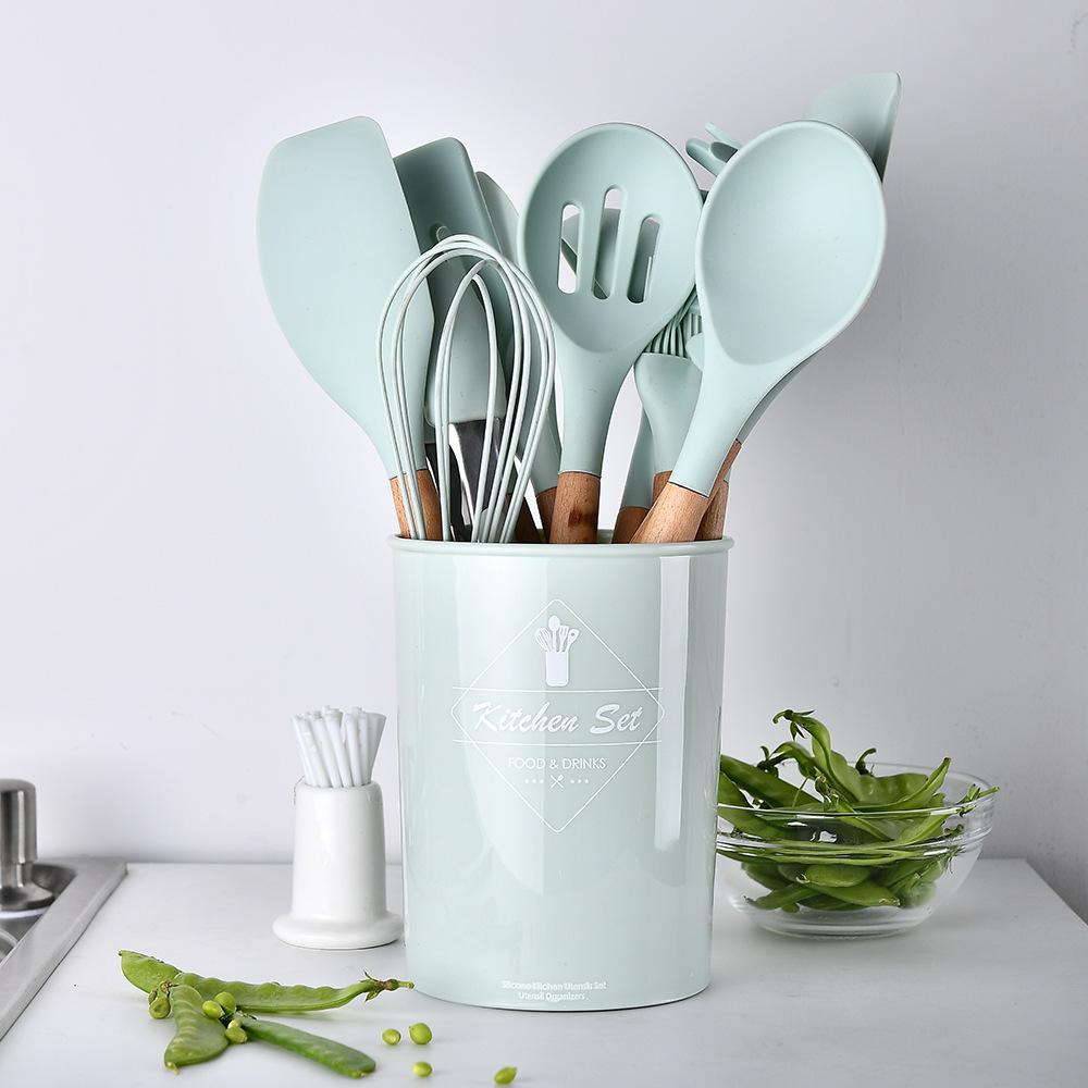 A vibrant 12-piece silicone kitchenware set including spatulas, spoons, and ladles with wooden handles, neatly arranged in a gift box.