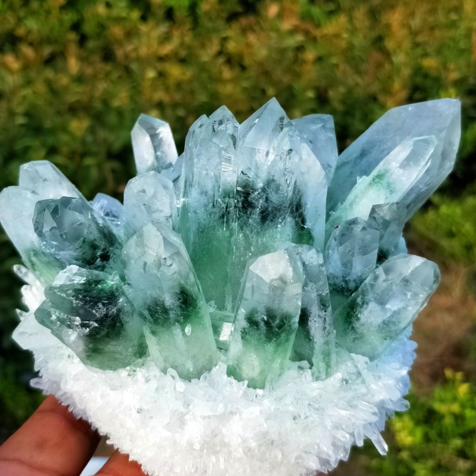 A beautiful Green Phantom Quartz Crystal showcasing its natural green inclusions and unique patterns, perfect for home decor.