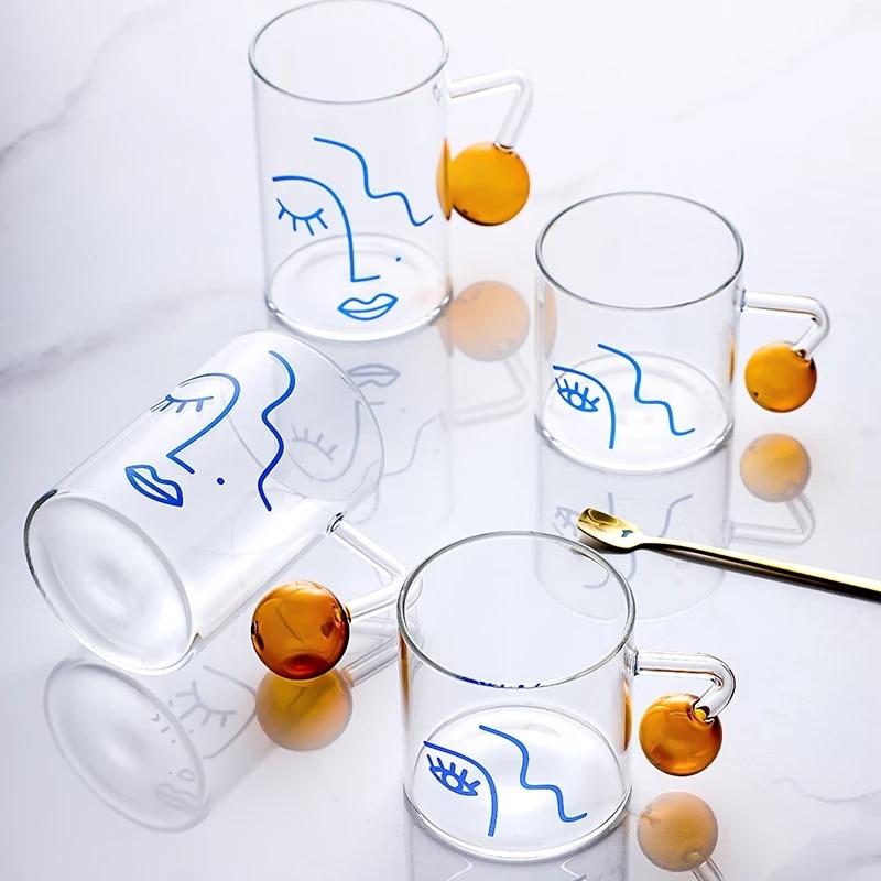 A stylish Abstract Glass Mug with unique artistic patterns, perfect for enjoying beverages.