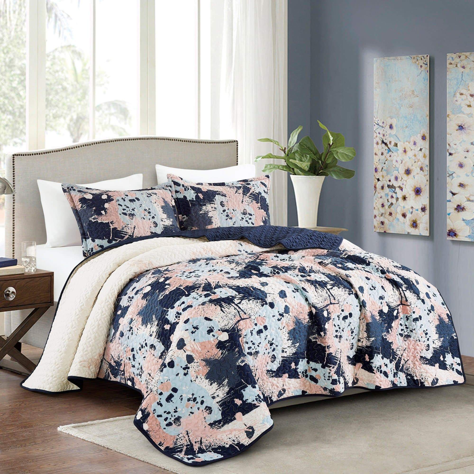 Abstract Hermia Contemporary Quilt Set featuring geometric and spotted patterns, elegantly displayed on a bed.