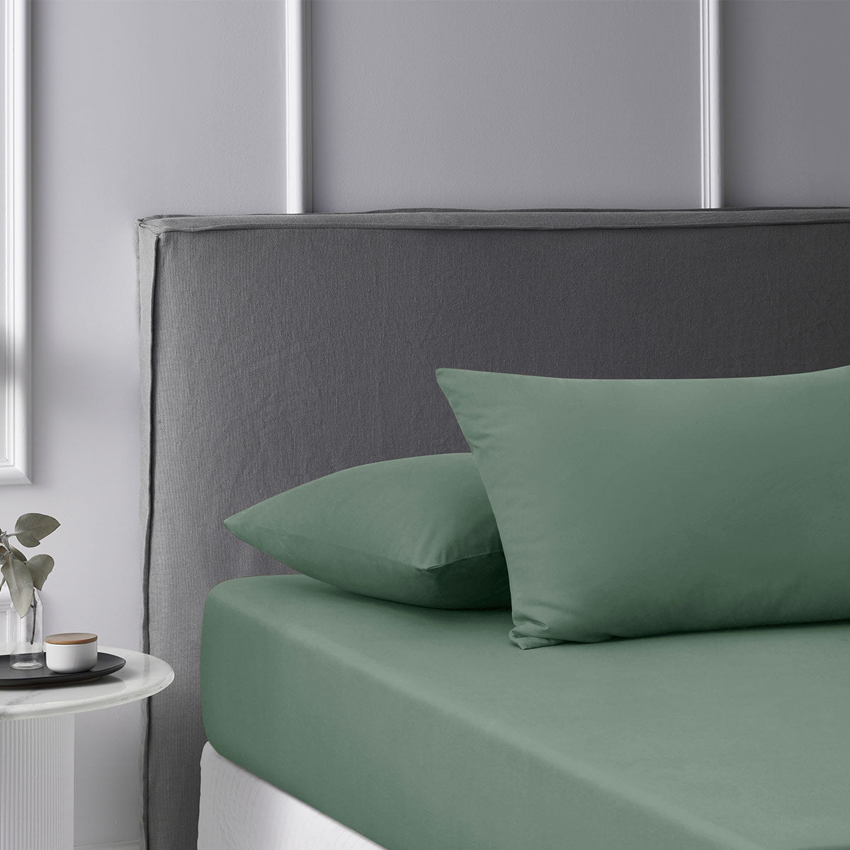 Accessorize Olive Washed Cotton Fitted Sheet Set displayed on a bed, featuring a solid olive color and soft texture.