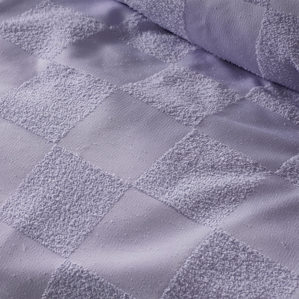 Accessorize Tipo Lilac Chenille Quilt Cover Set featuring a textured grid pattern, includes quilt cover and two pillowcases in a soft lilac color.