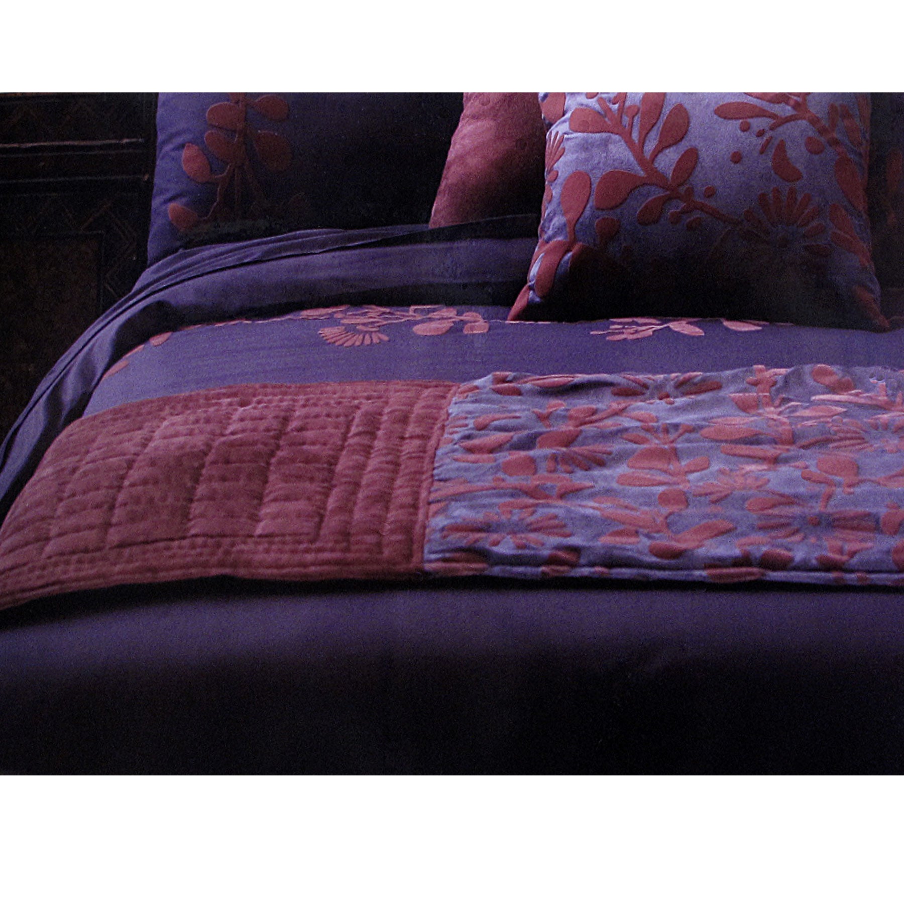 Accessorize Utopia Purple Bed Runner featuring a flocking floral design in plum and purple tones, elegantly draped across a bed.