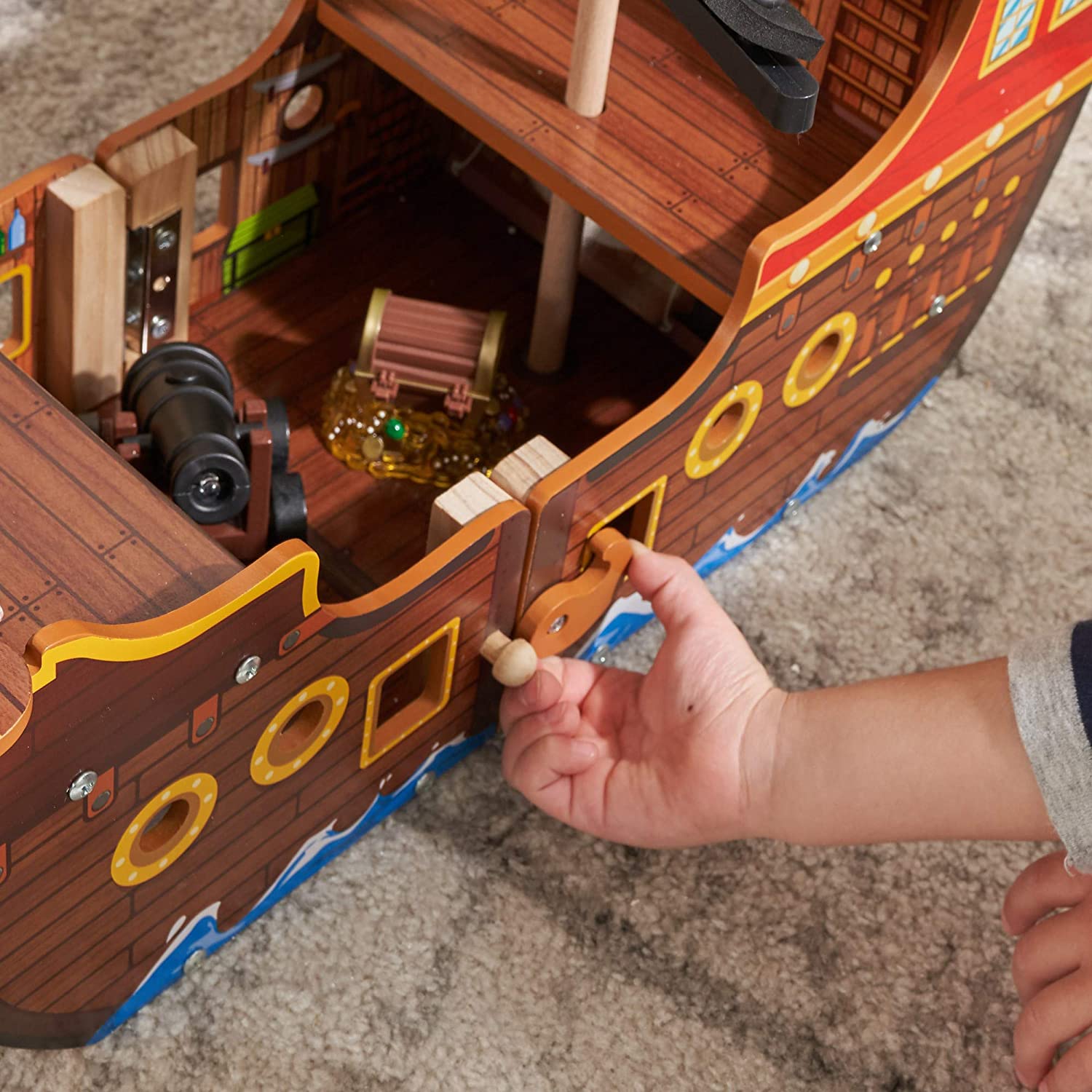 Adventure Bound Pirate Ship for kids, featuring a wooden design with interactive elements like a cannon that lights up and makes sounds.