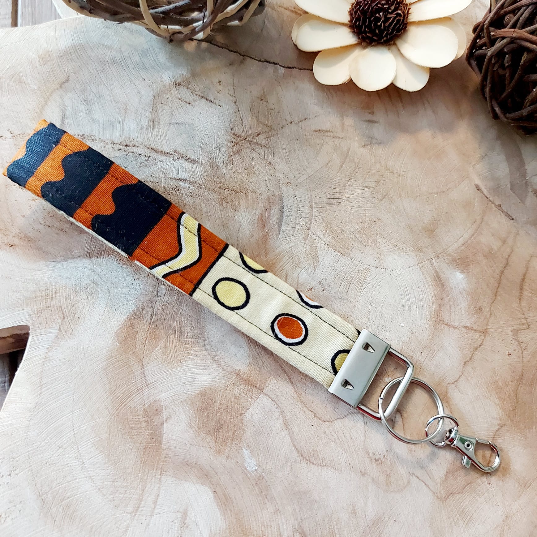 African Print and Leather Key Fob wristlet, featuring vibrant fabric and sturdy vegan leather lining, perfect for key organization.