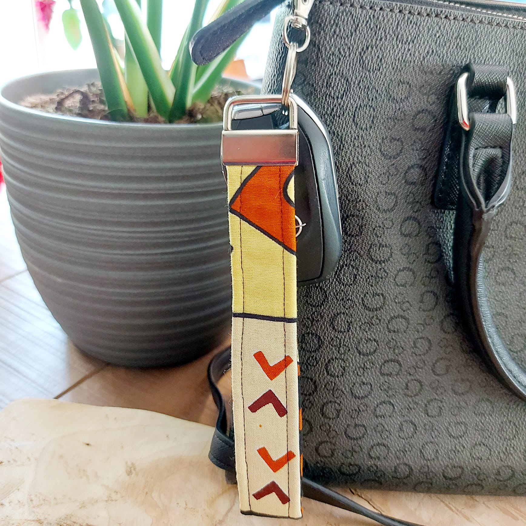 African Print and Leather Key Fob wristlet, featuring vibrant fabric and sturdy vegan leather lining, perfect for key organization.