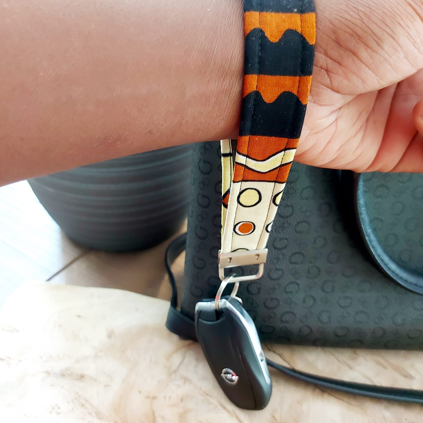 African Print and Leather Key Fob wristlet, featuring vibrant fabric and sturdy vegan leather lining, perfect for key organization.