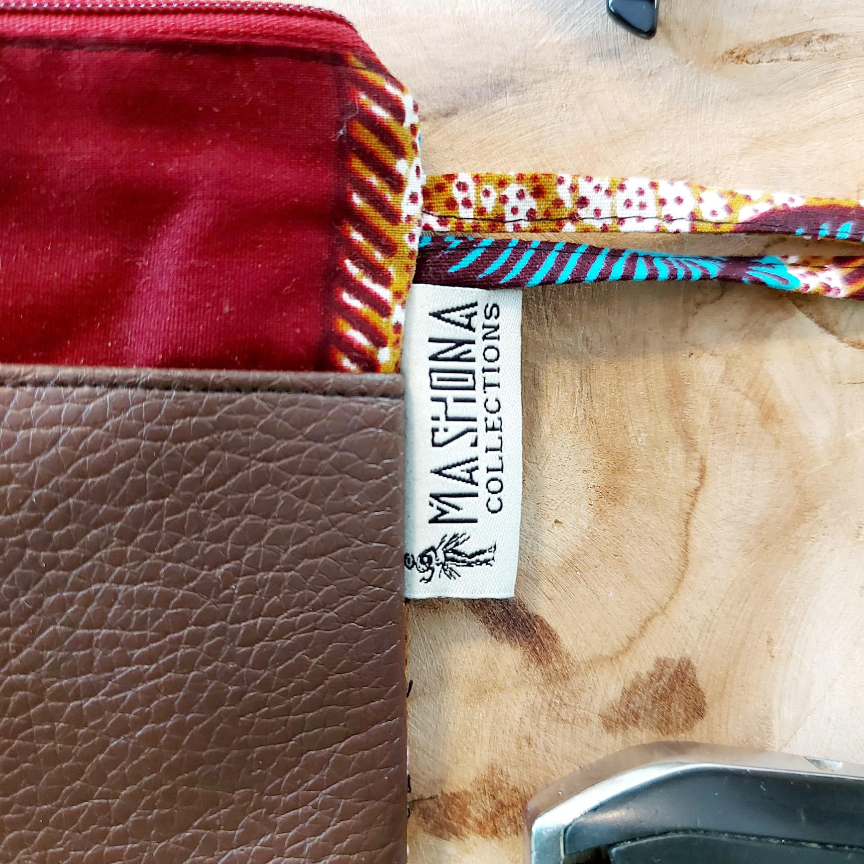 Colorful African Print Zipper Pouch made of vegan leather, showcasing unique wax prints and a durable design, perfect for make-up or stationery.