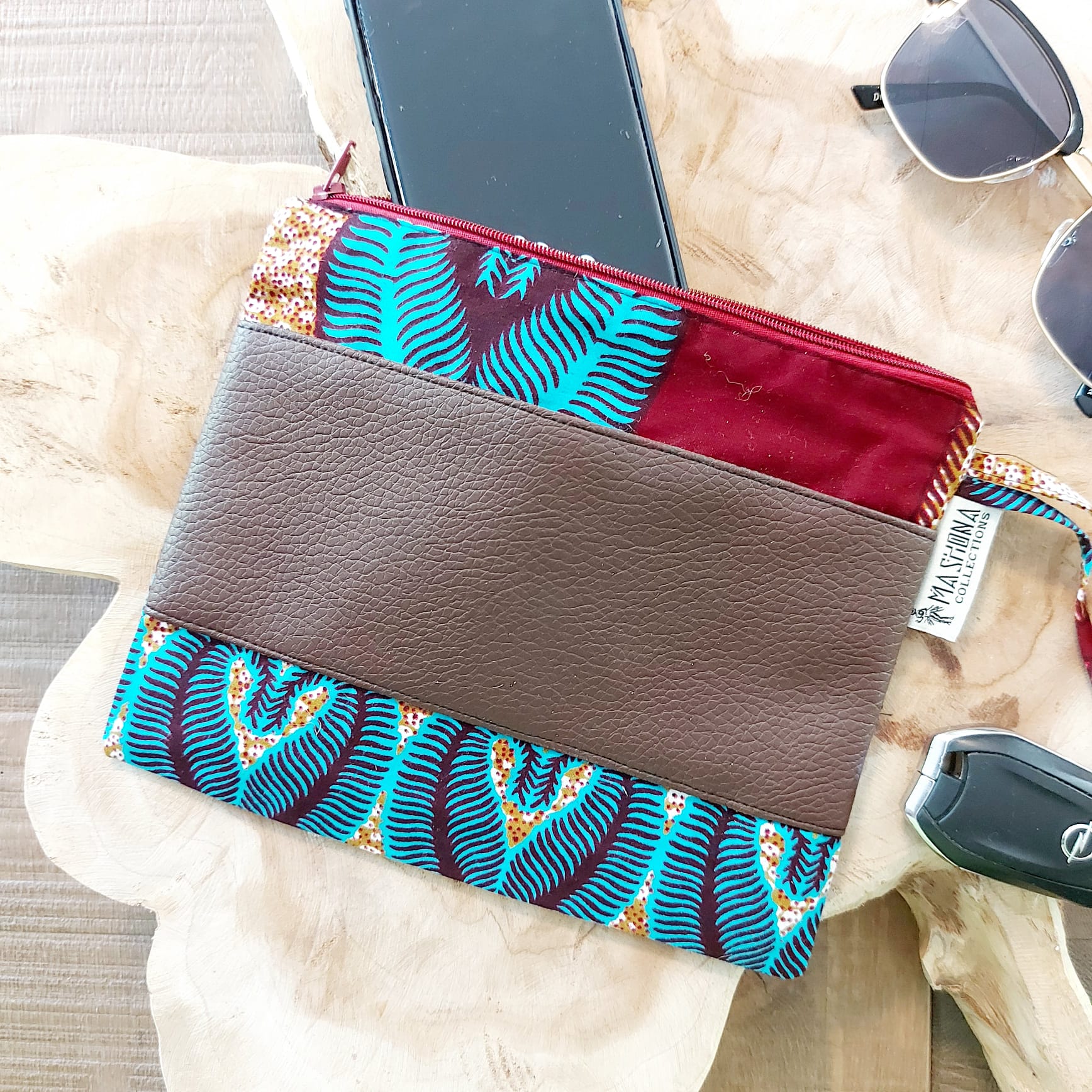 Colorful African Print Zipper Pouch made of vegan leather, showcasing unique wax prints and a durable design, perfect for make-up or stationery.