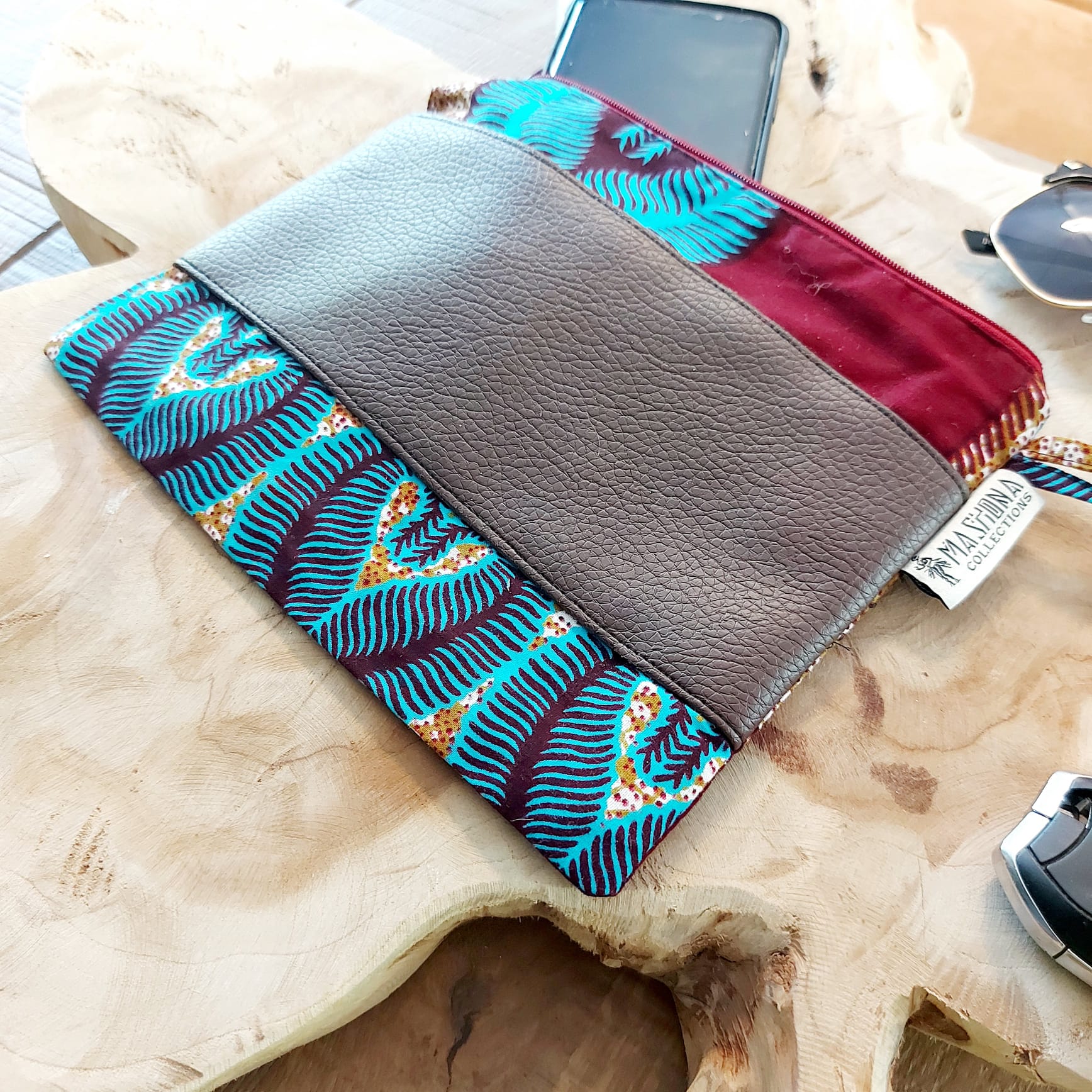 Colorful African Print Zipper Pouch made of vegan leather, showcasing unique wax prints and a durable design, perfect for make-up or stationery.