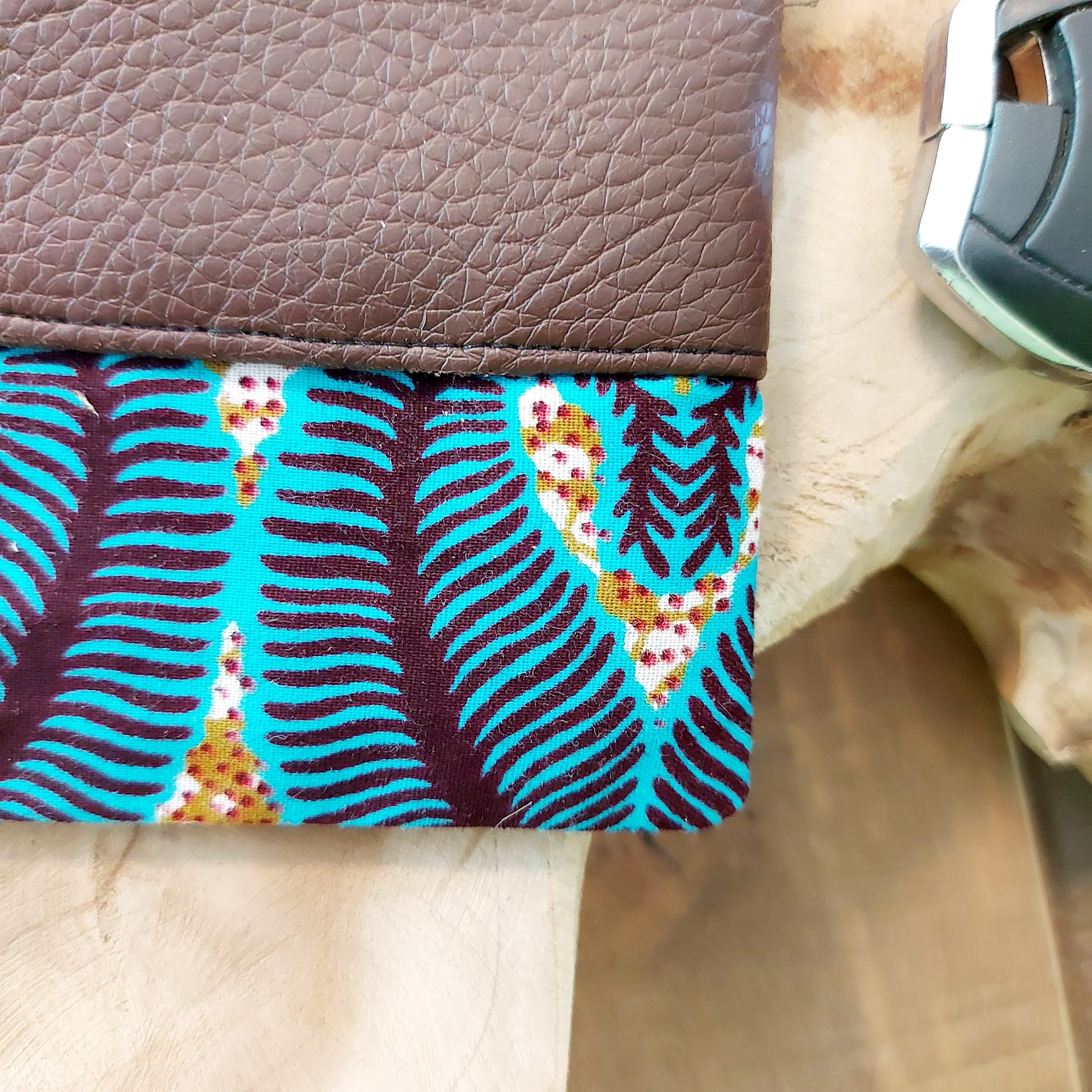 Colorful African Print Zipper Pouch made of vegan leather, showcasing unique wax prints and a durable design, perfect for make-up or stationery.