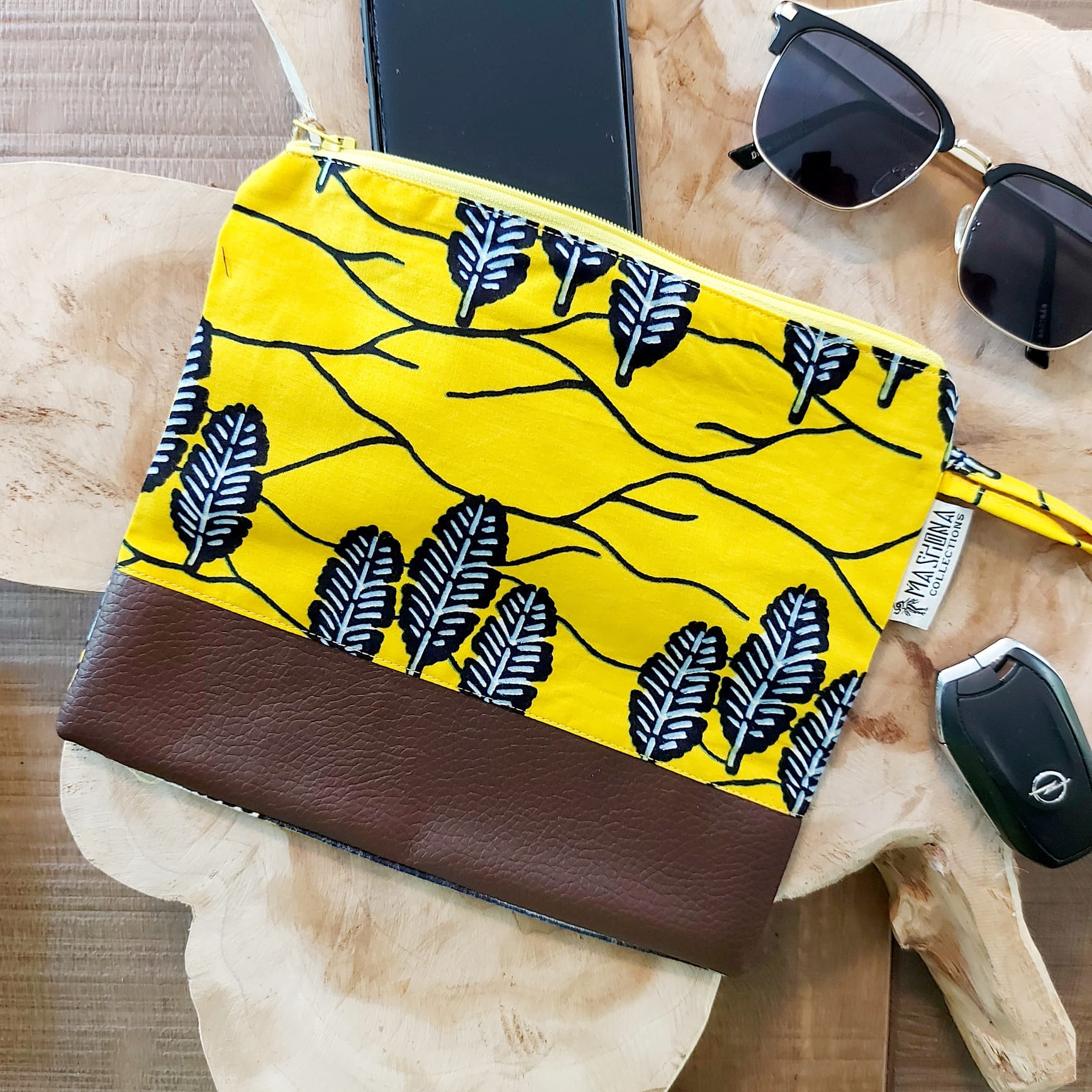 Colorful African Print Zipper Pouch made of vegan leather, showcasing unique wax prints and a durable design, perfect for make-up or stationery.