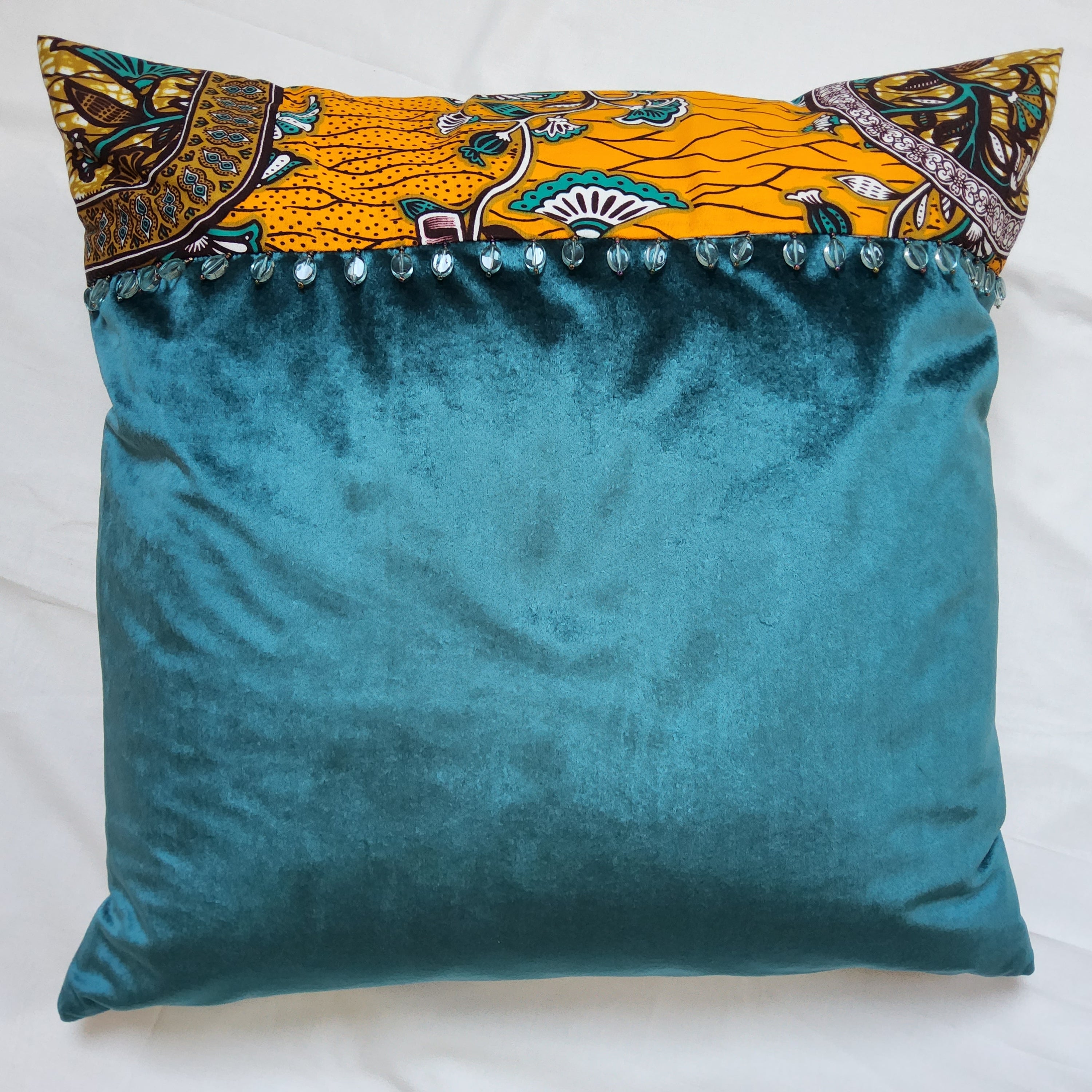 AfroBrit Fusion 50x50cm square cushion featuring vibrant Ankara fabric and luxurious velvet finish, perfect for home decor.