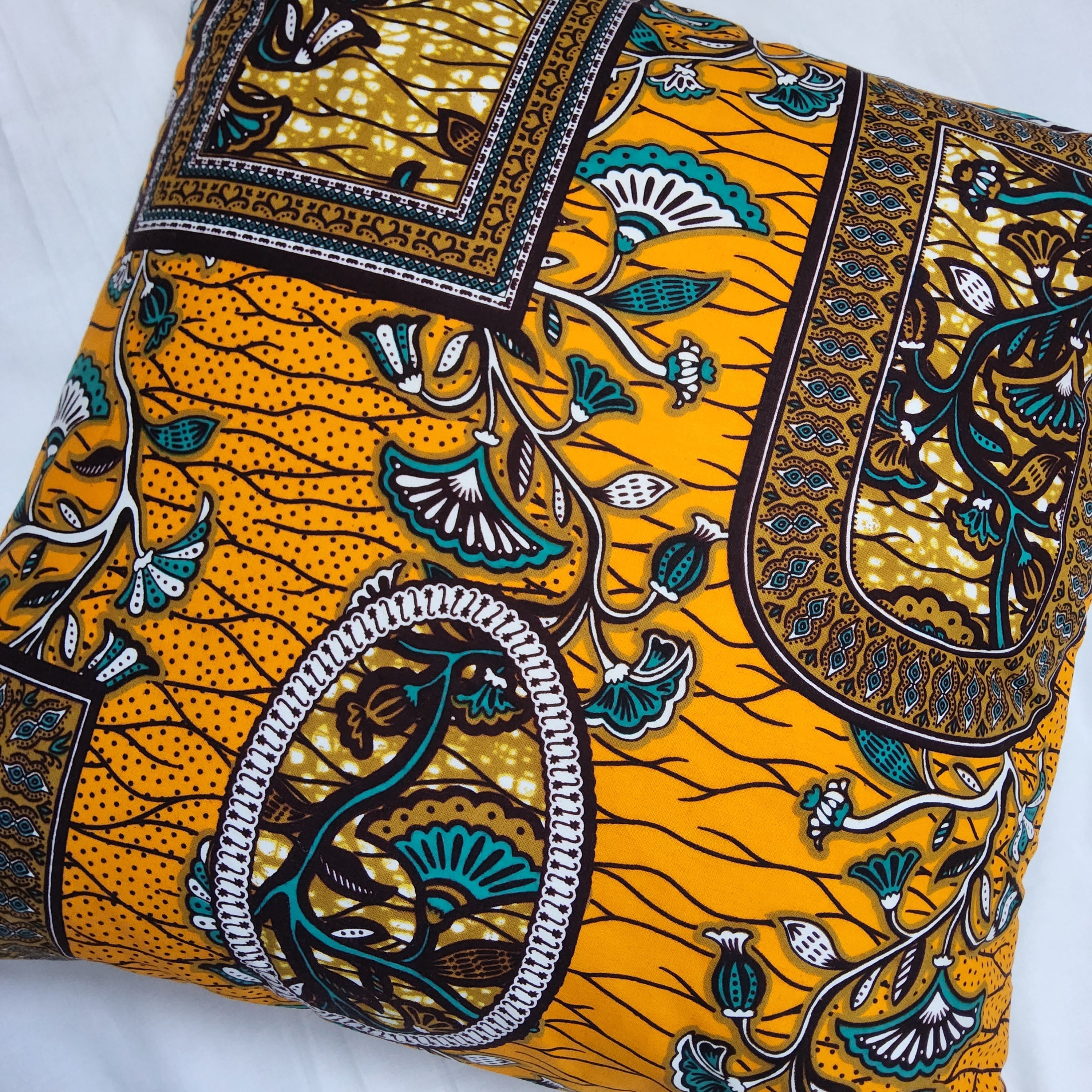 AfroBrit Fusion 50x50cm square cushion featuring vibrant Ankara fabric and luxurious velvet finish, perfect for home decor.