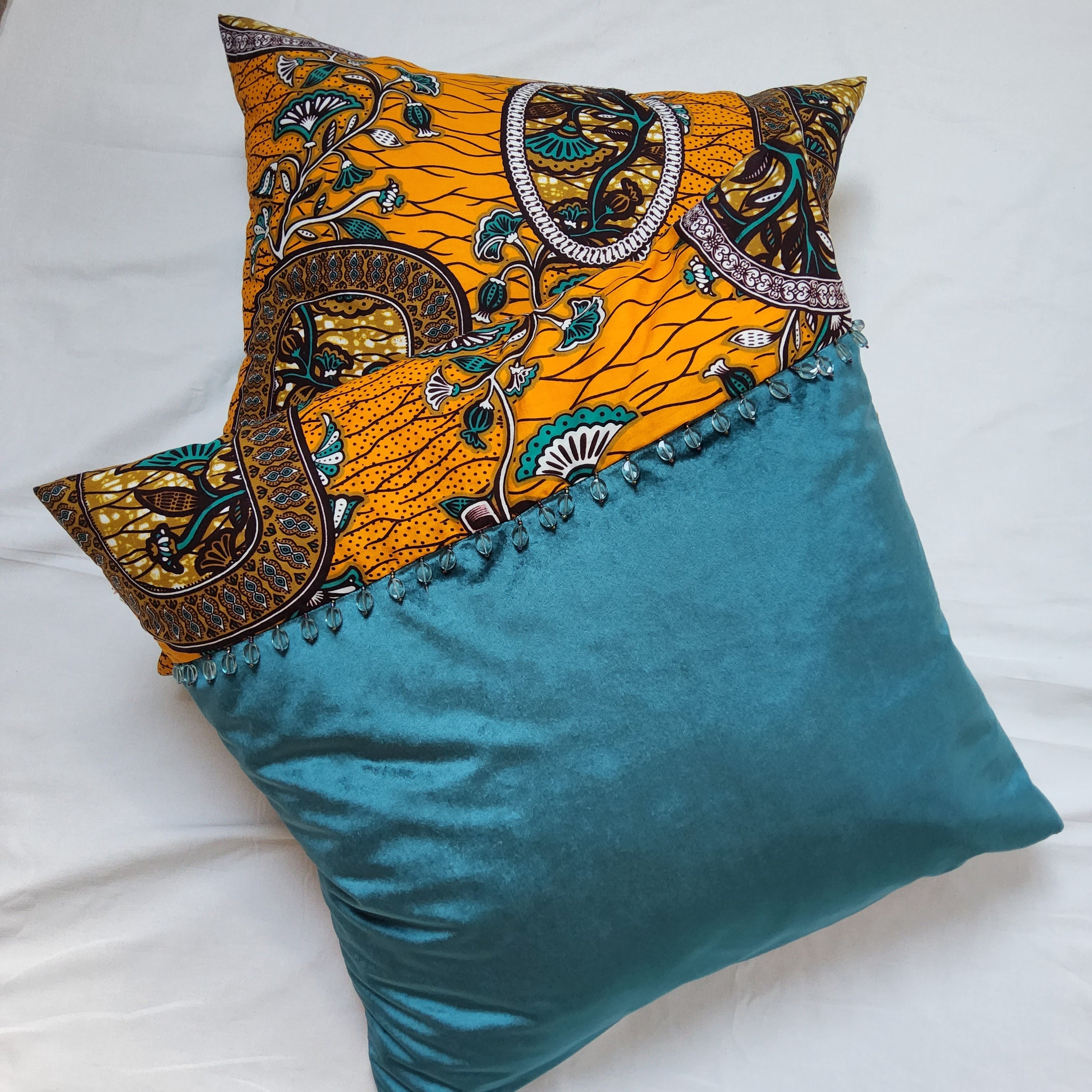 AfroBrit Fusion 50x50cm square cushion featuring vibrant Ankara fabric and luxurious velvet finish, perfect for home decor.