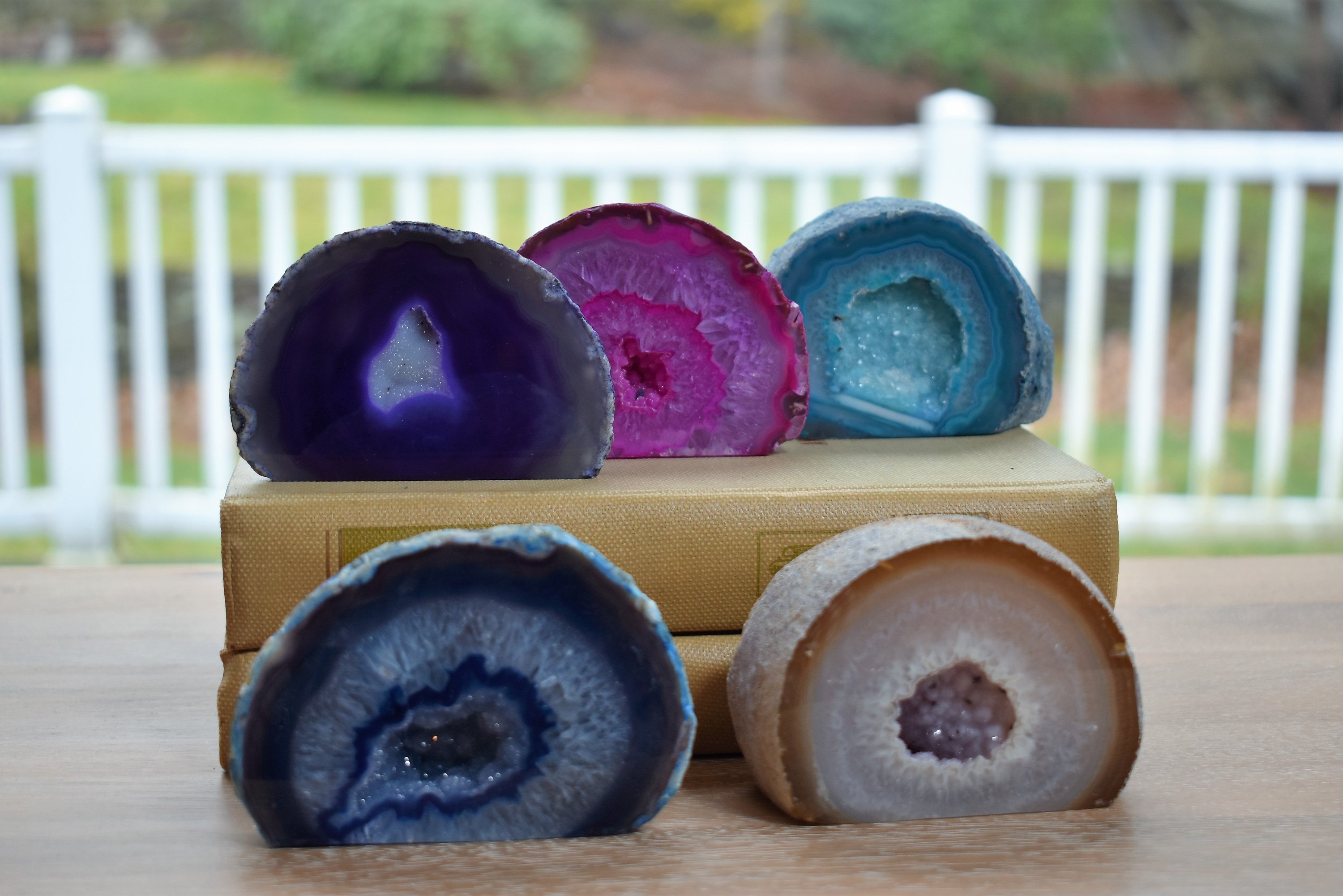 A collection of small, medium, and large agate geodes showcasing vibrant colors and unique crystal formations, perfect for home decoration.