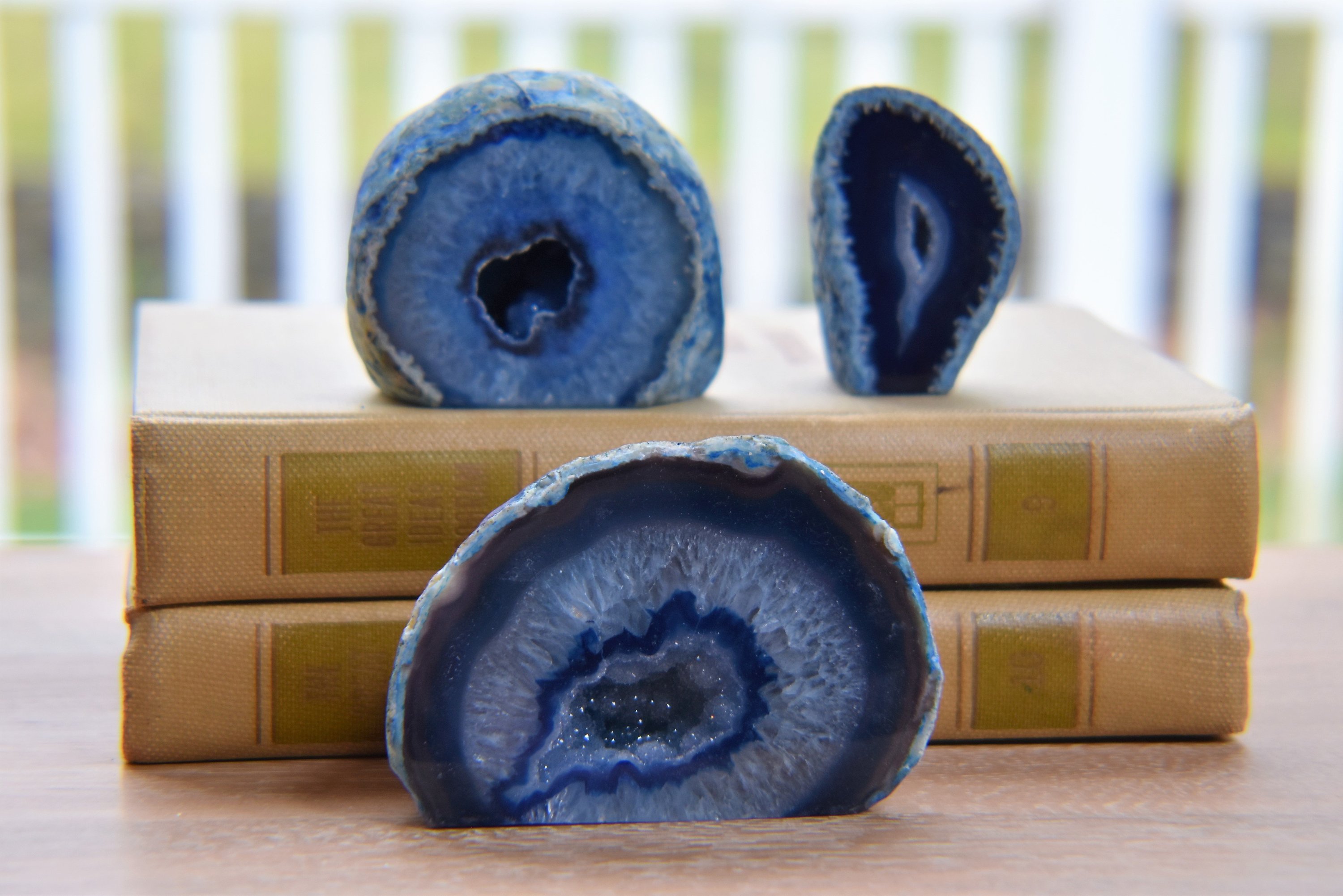 A collection of small, medium, and large agate geodes showcasing vibrant colors and unique crystal formations, perfect for home decoration.