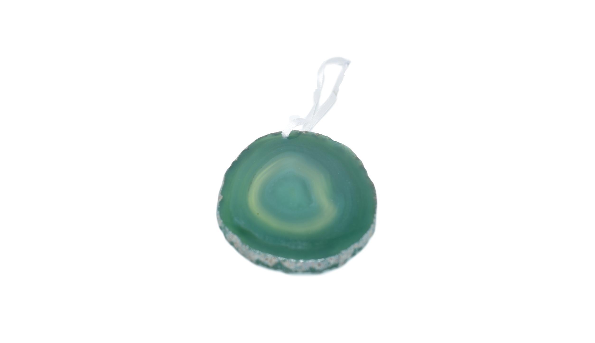 A beautiful agate ornament with a polished natural trim, hanging from a white silk ribbon, showcasing its unique colors and patterns.