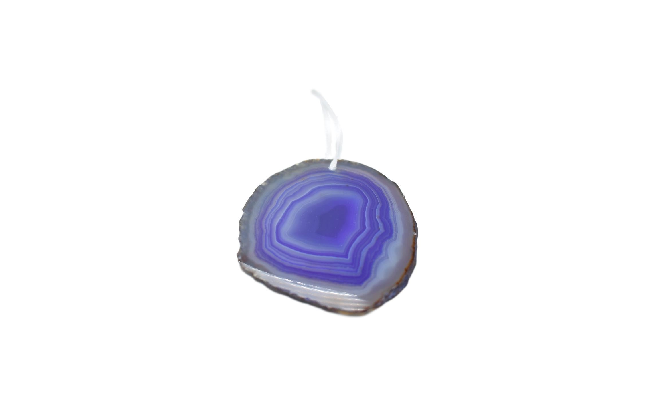 A beautiful agate ornament with a polished natural trim, hanging from a white silk ribbon, showcasing its unique colors and patterns.