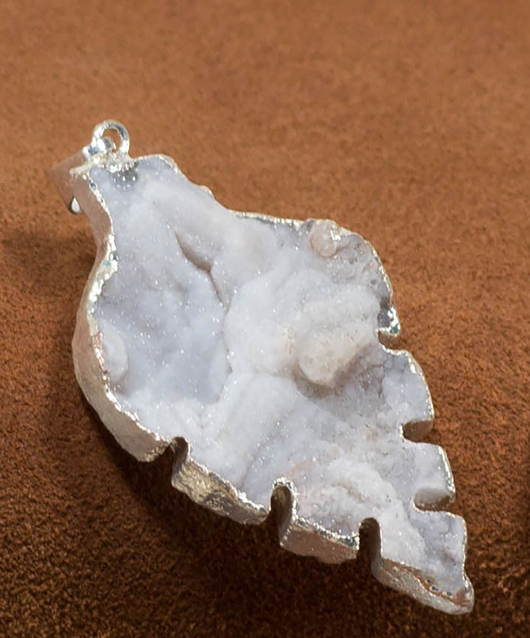 A collection of elegant agate sculpture pendants in various designs, including leaf, heart, and dolphin, trimmed in silver and gold.