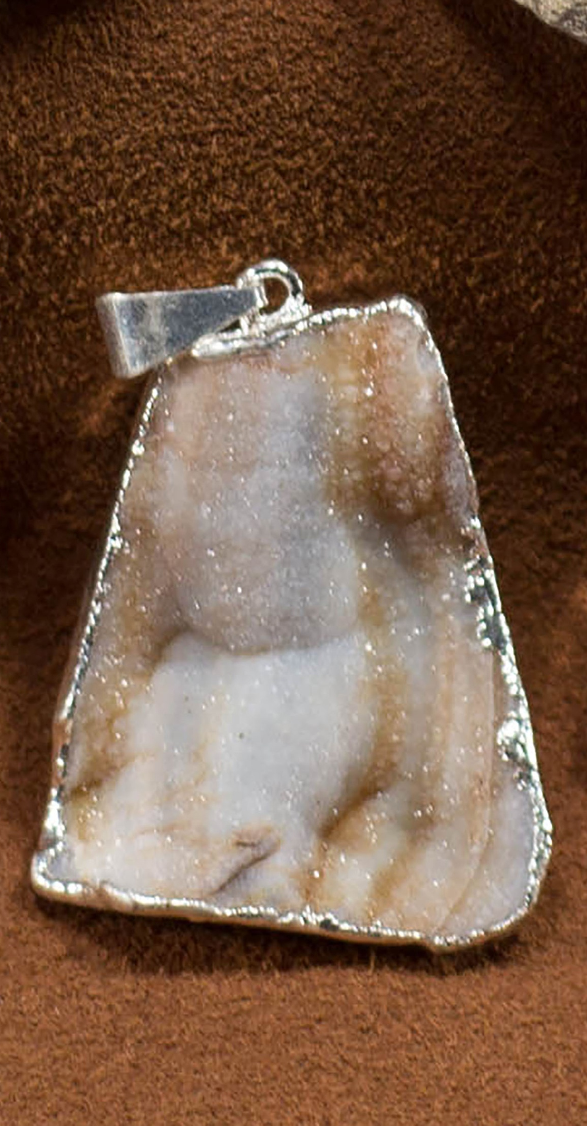 A collection of elegant agate sculpture pendants in various designs, including leaf, heart, and dolphin, trimmed in silver and gold.