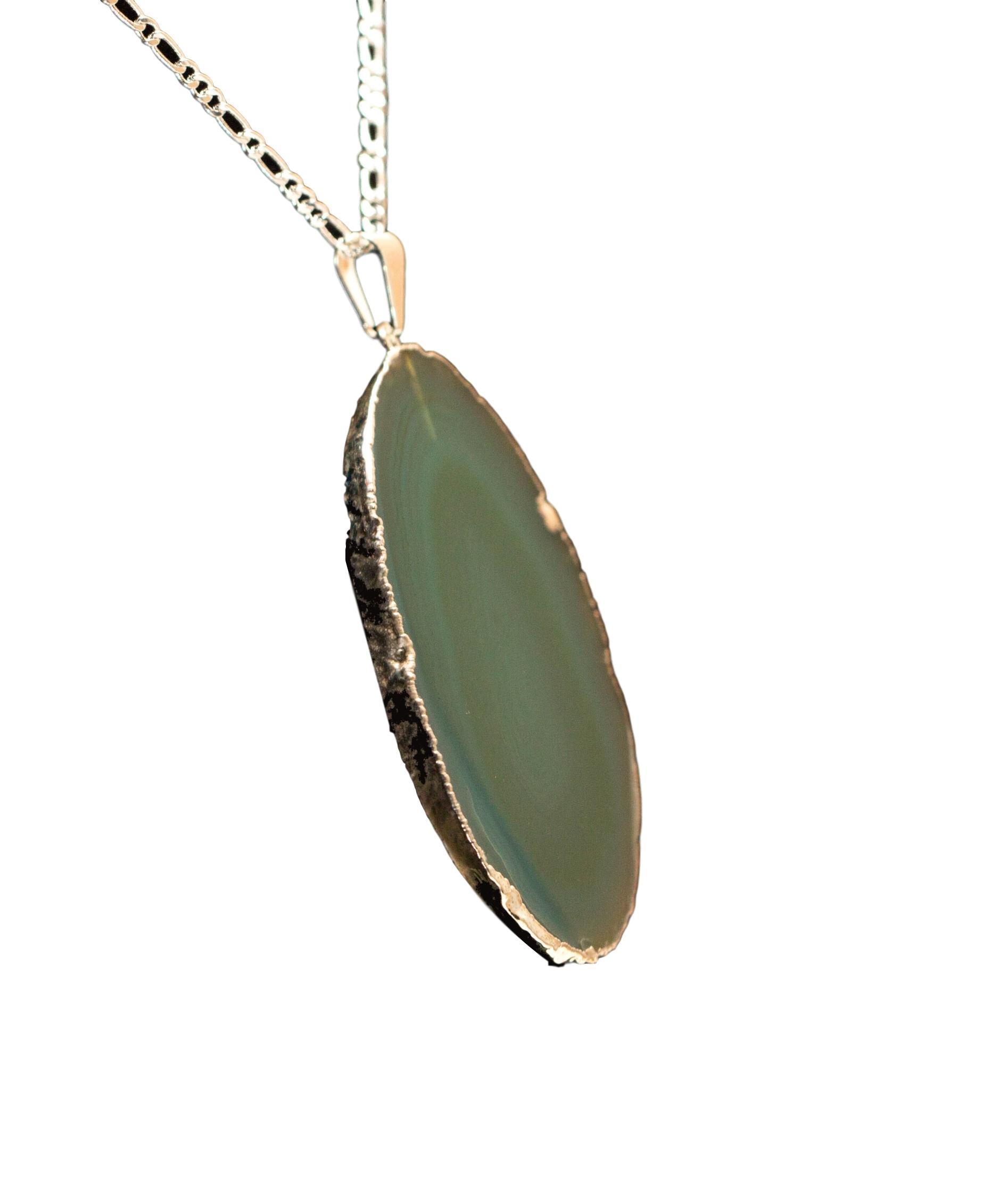 A beautiful Agate Slice Pendant with silver trim, showcasing unique natural patterns and colors, perfect for elegant jewelry collections.