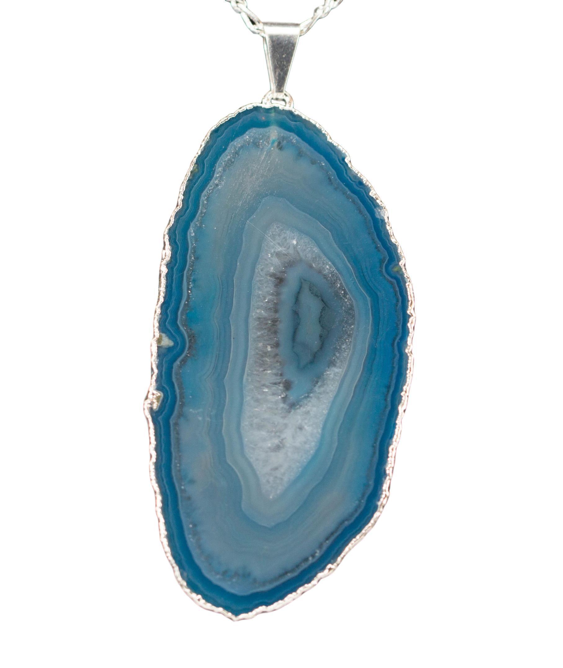 A beautiful Agate Slice Pendant with silver trim, showcasing unique natural patterns and colors, perfect for elegant jewelry collections.