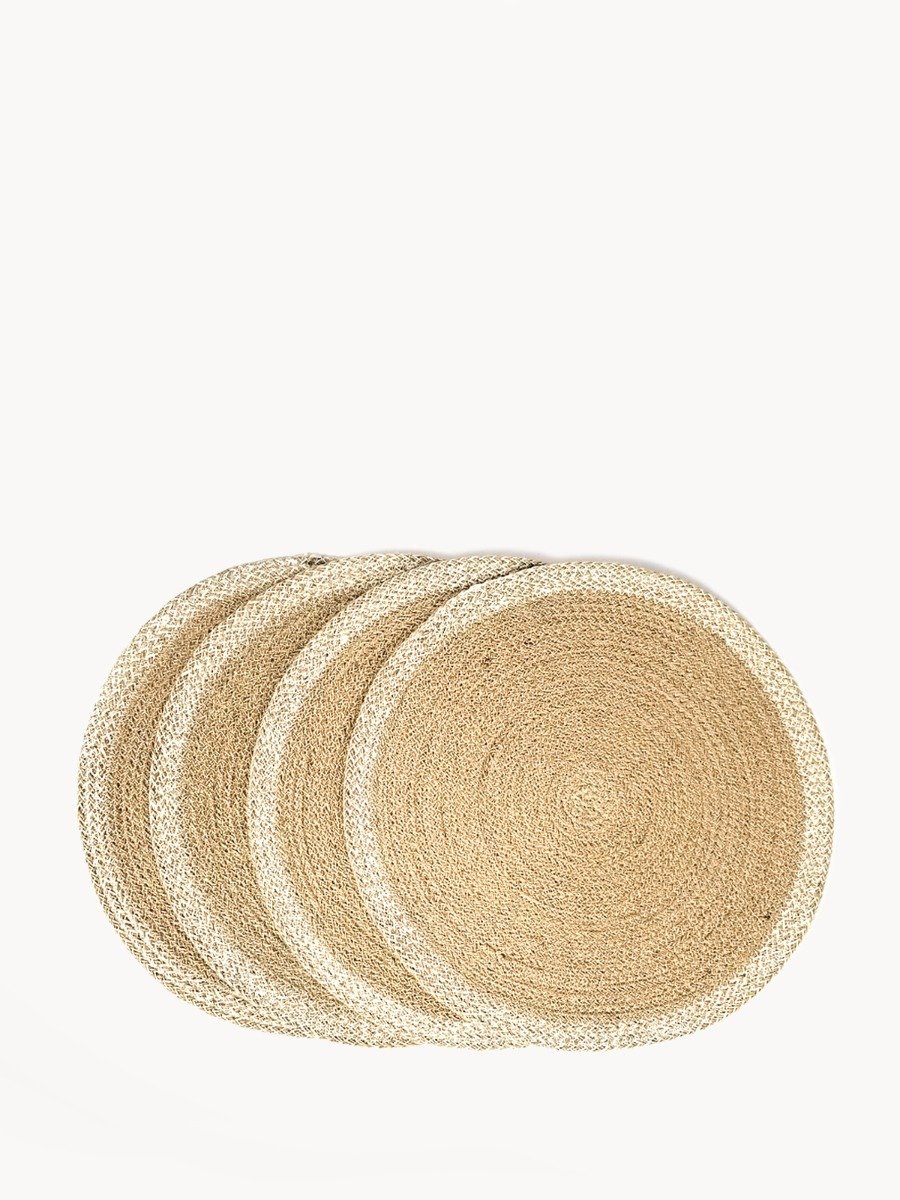 Set of 4 round jute placemats in natural and white colors, showcasing their textured design and handcrafted quality.