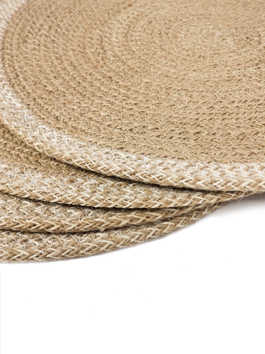 Set of 4 round jute placemats in natural and white colors, showcasing their textured design and handcrafted quality.