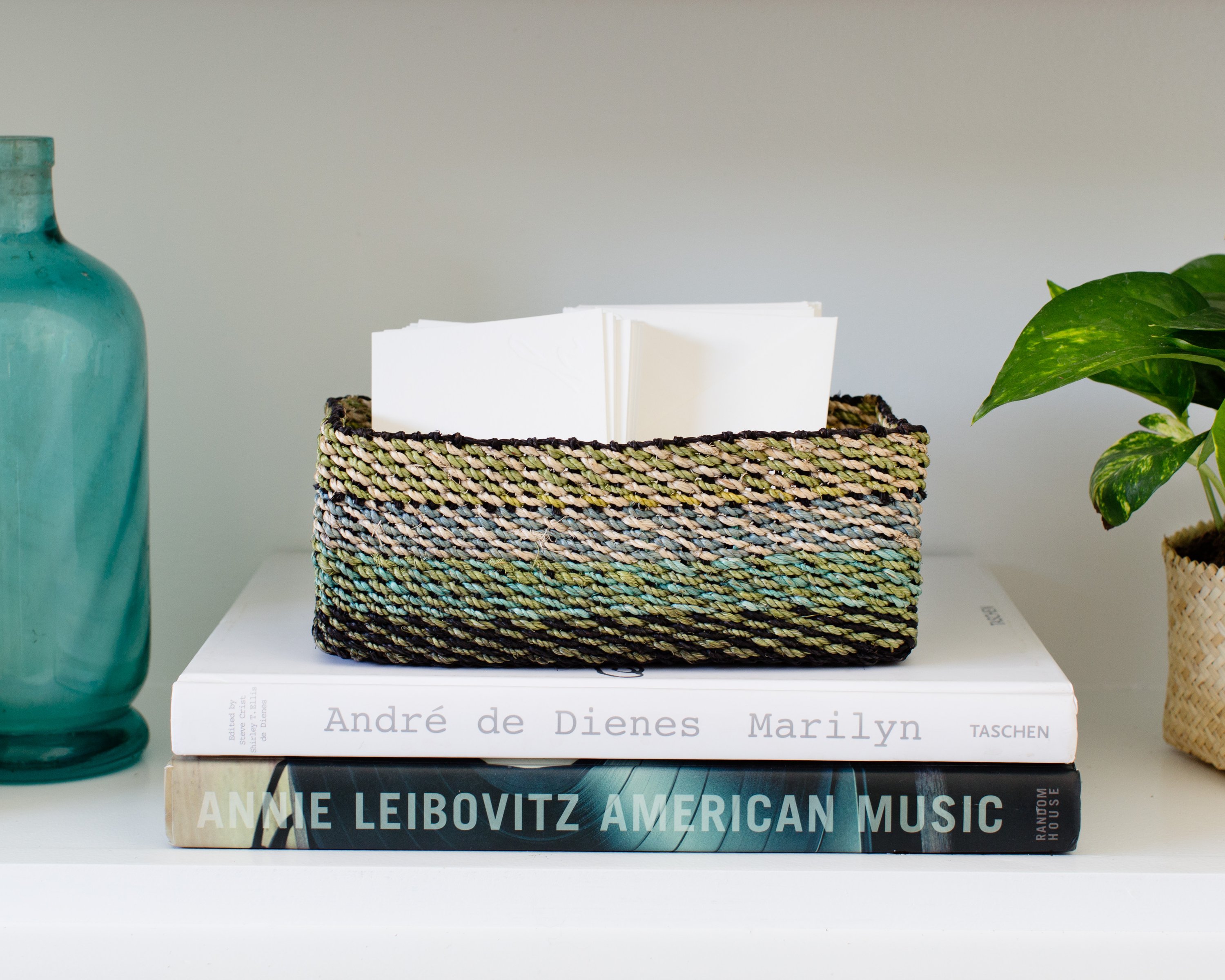 Light green handwoven storage tray made from seagrass, perfect for organizing small items in a stylish way.