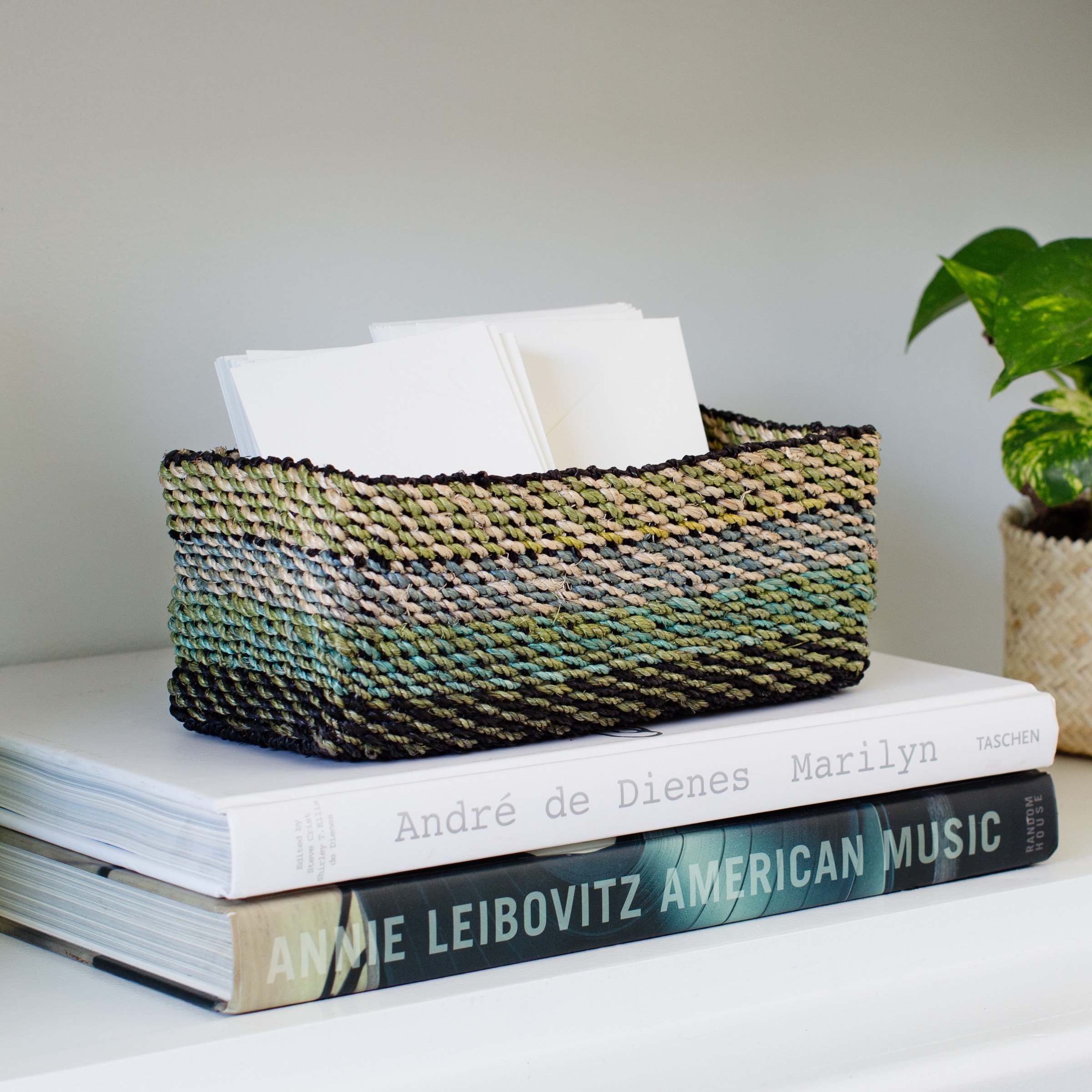 Light green handwoven storage tray made from seagrass, perfect for organizing small items in a stylish way.