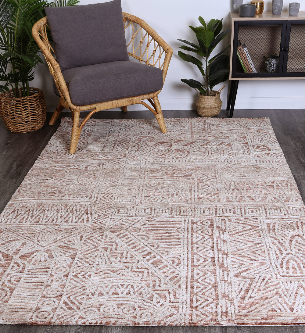 Alayah Rust Flower Rug 160x230 cm featuring geometric patterns in warm rust and cream colors, hand-tufted wool texture.