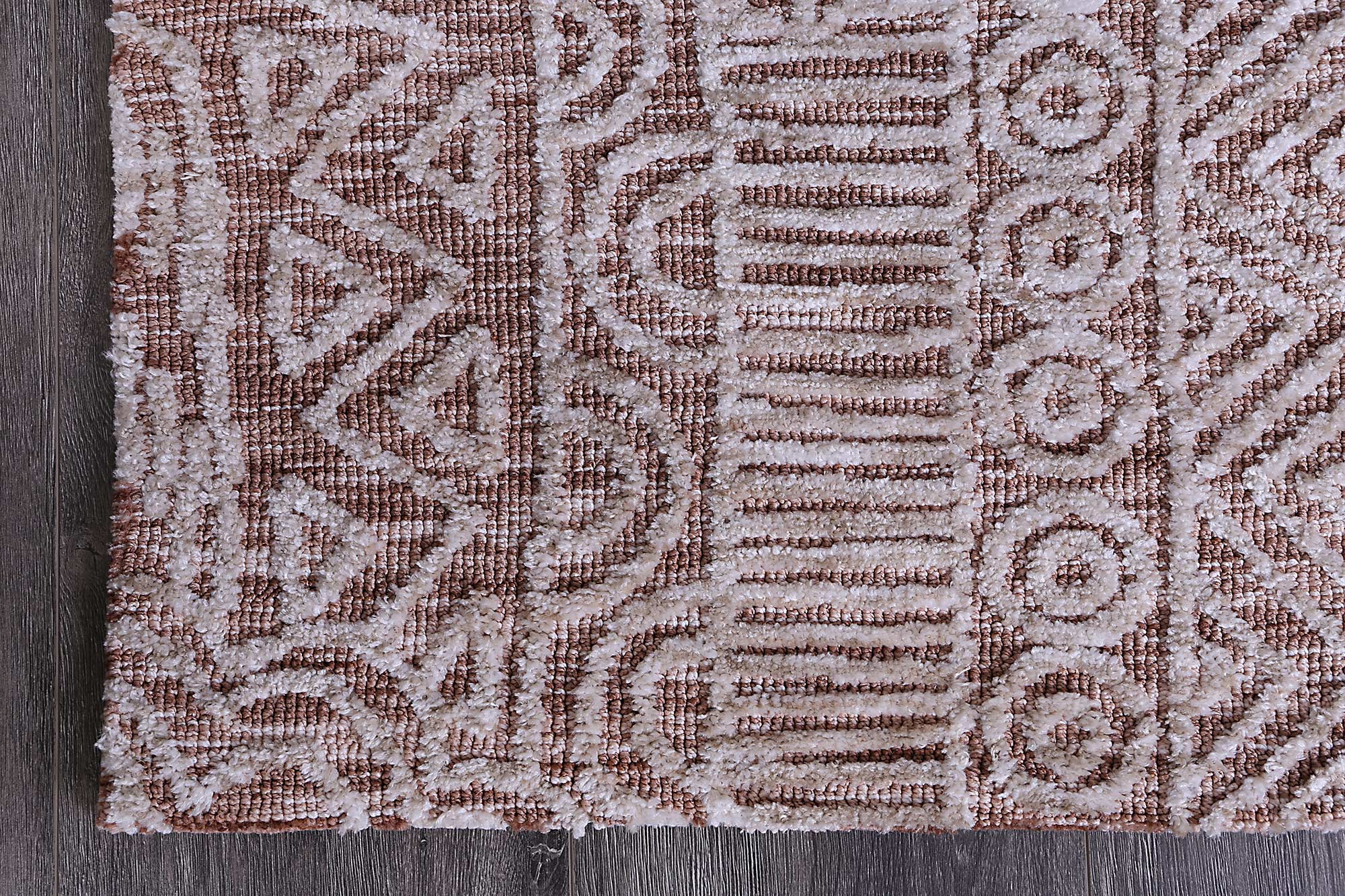 Alayah Rust Flower Rug 160x230 cm featuring geometric patterns in warm rust and cream colors, hand-tufted wool texture.