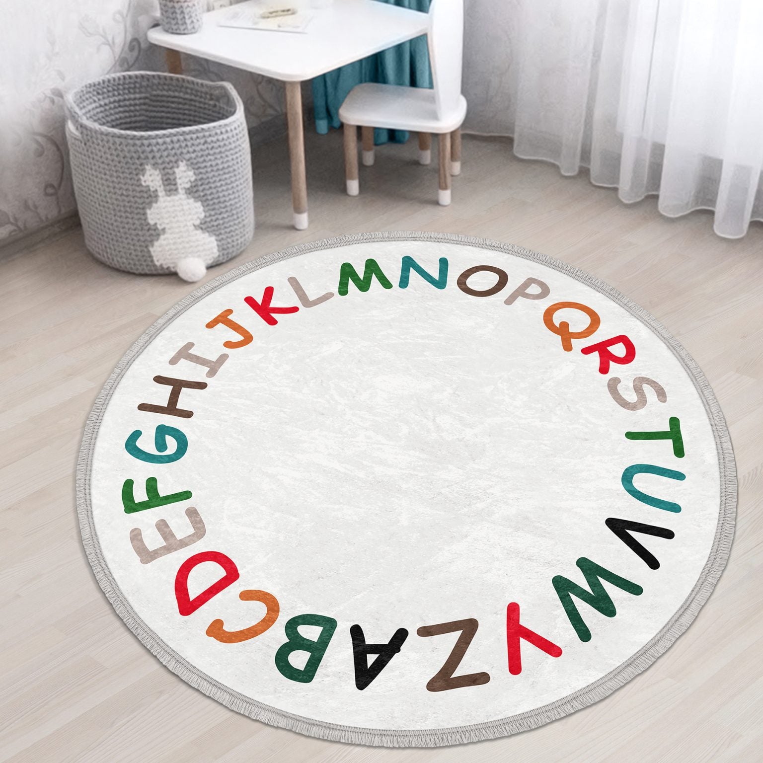 Colorful Alphabet Design Round Rug for Kids Room, featuring soft velvet fabric and fringes, perfect for nursery decor.