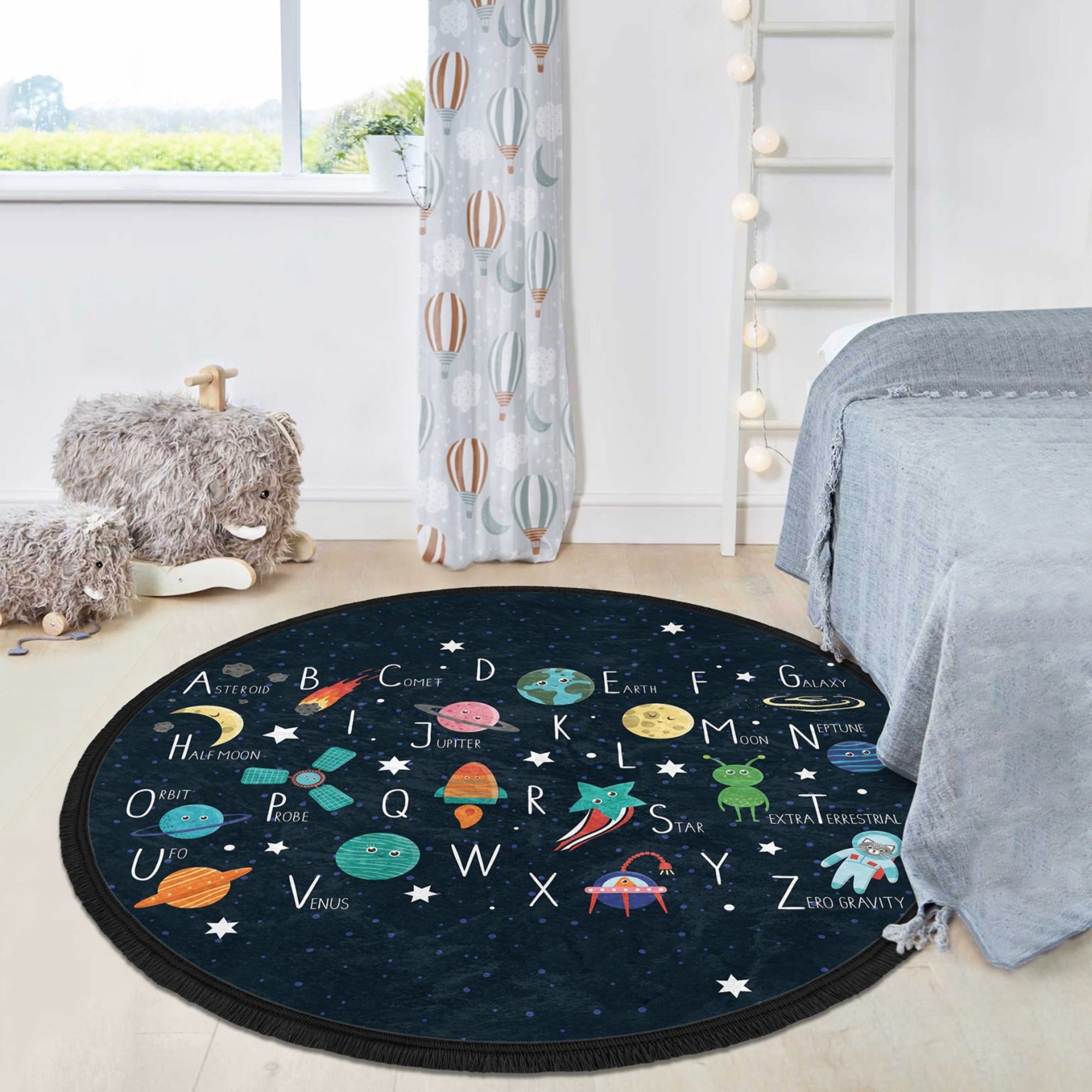 Colorful round area rug featuring alphabet letters and space design, perfect for kids' rooms and nurseries.