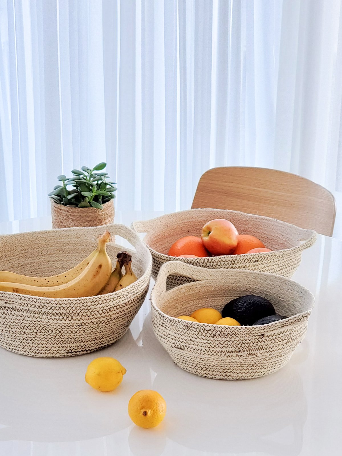 Amari Fruit Bowl in brown, handwoven jute with black stitching, showcasing its elegant design and craftsmanship.