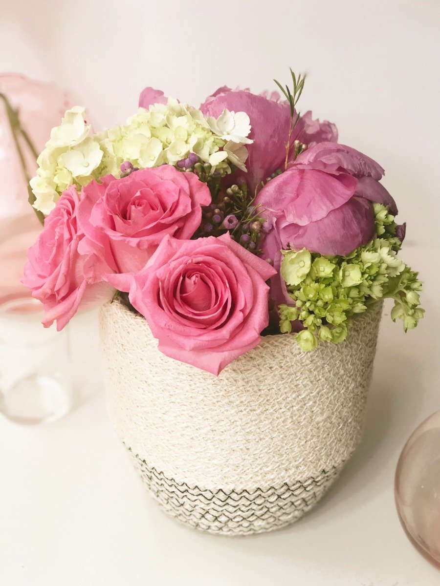 Amari Loop Bin in black with three thin bud vases, showcasing its handcrafted jute design.