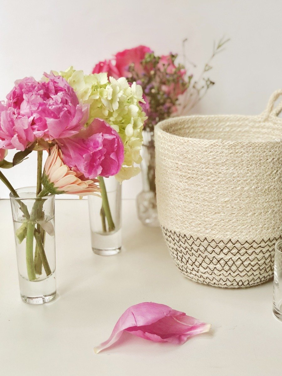 Amari Loop Bin in black with three thin bud vases, showcasing its handcrafted jute design.