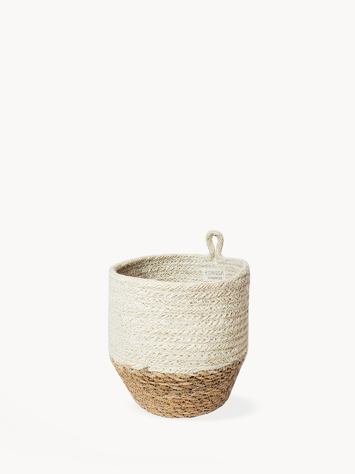 Amari Loop Bin in natural jute and seagrass, showcasing its round shape and off-white color, perfect for stylish storage.