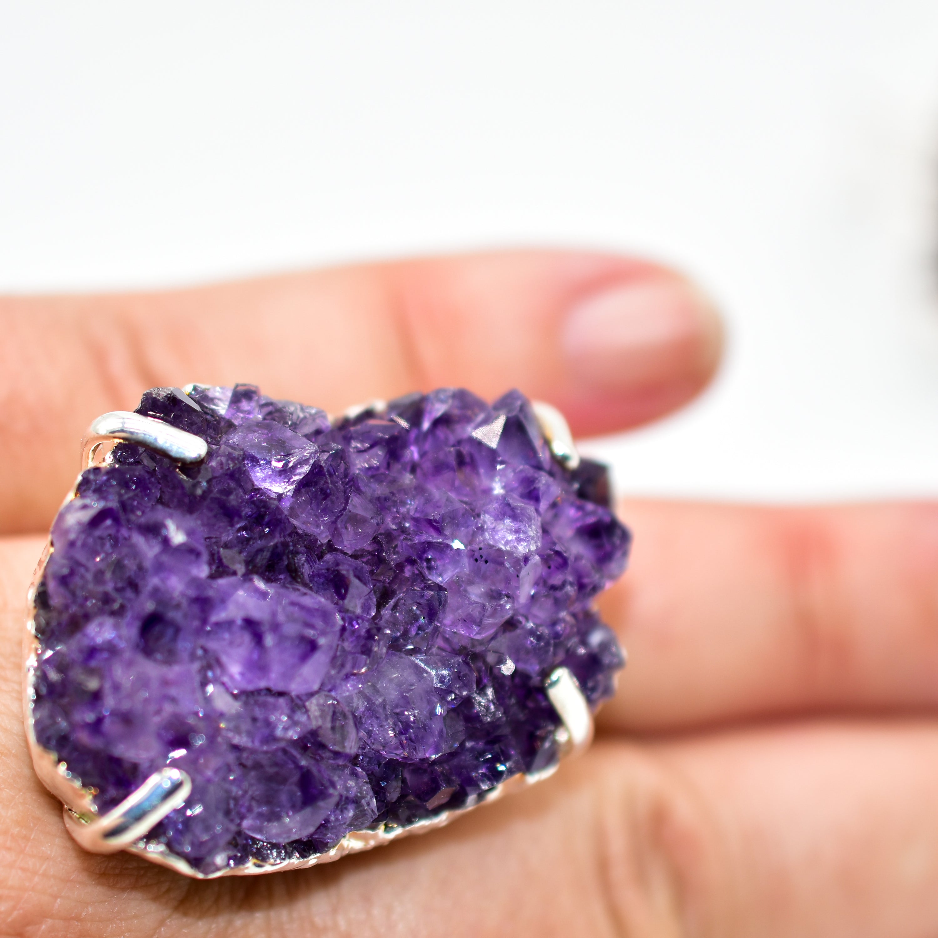 A stunning Amethyst Druzy Ring featuring a natural druzy stone wrapped in silver electroplating, showcasing its unique shape and vibrant color.