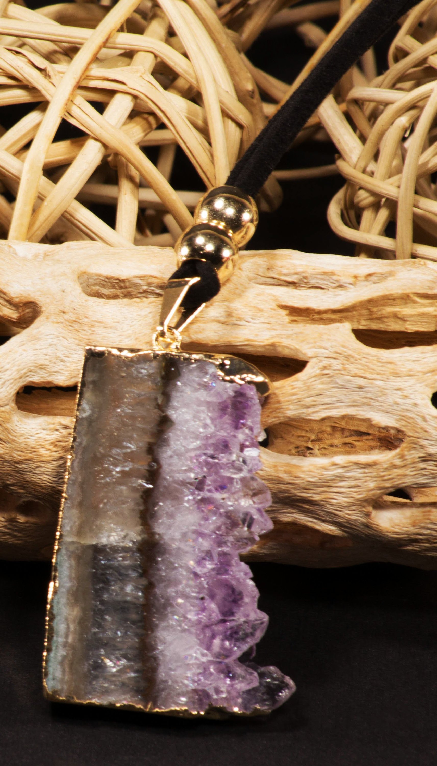 Amethyst vertical slice pendant on a leather necklace, showcasing its unique purple hues and elegant trim.