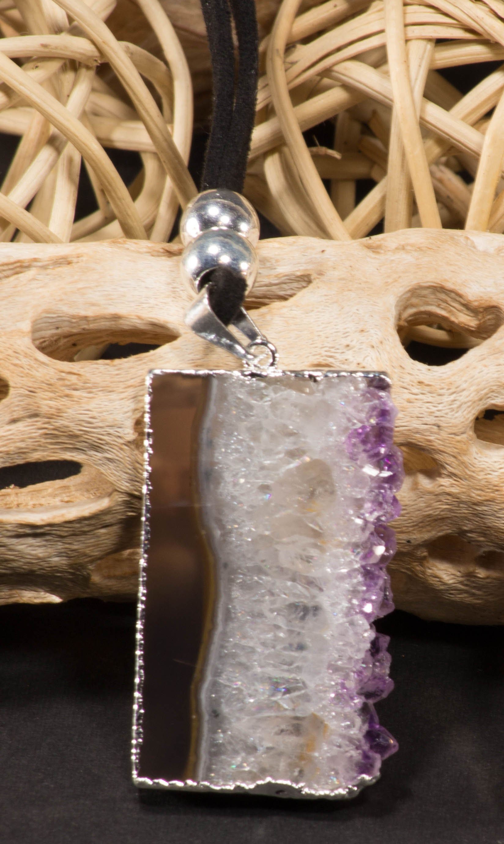 Amethyst vertical slice pendant on a leather necklace, showcasing its unique purple hues and elegant trim.