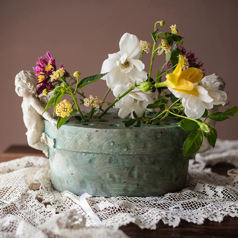 Angel Lotus Pot Flower Arrangement Vase with cherub accents and mint green glaze, perfect for floral displays.