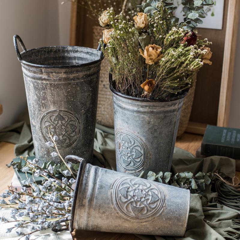 Antique Floral Carving Iron Flower Pot in gray with intricate floral designs, available in three sizes.